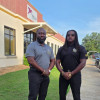 Edwin Allen (left) and Carlos Brooks (right) get ready to talk to workers at Trojan Battery in Sandersville, Georgia